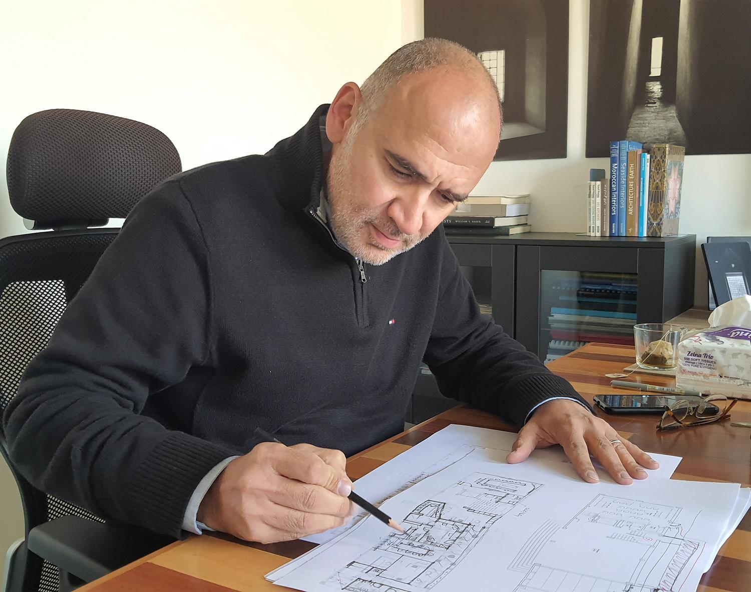 A principal at the drawing board in the Cairo studio